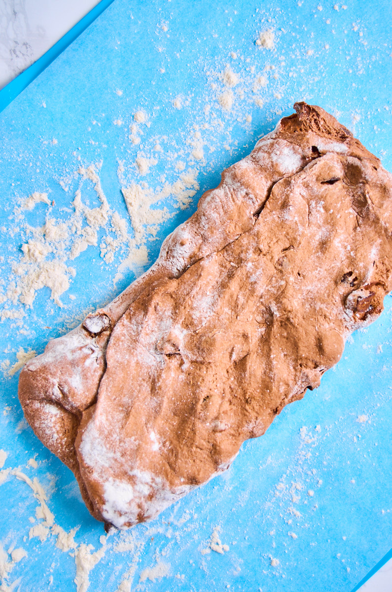 The dough is turned at a 90 degree angle and patted into a long rectangle.