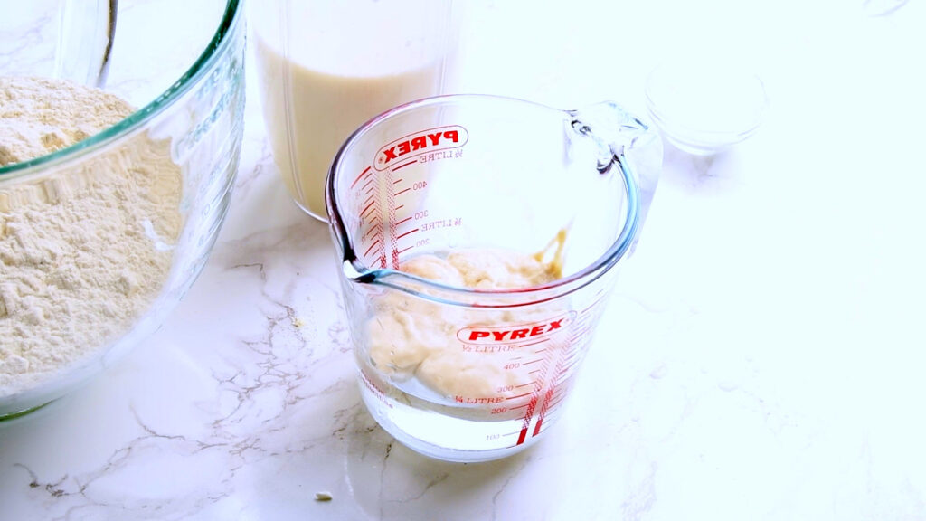 Mixing the sourdough starter into the water for the Protein Sourdough Focaccia